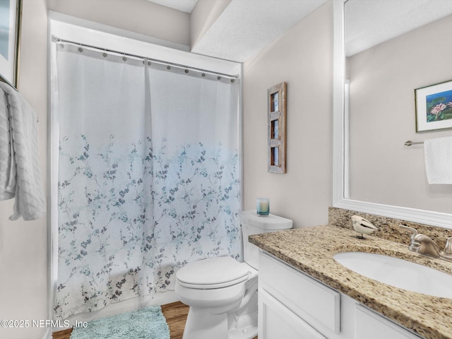 full bathroom with shower / bath combo, vanity, toilet, and wood finished floors