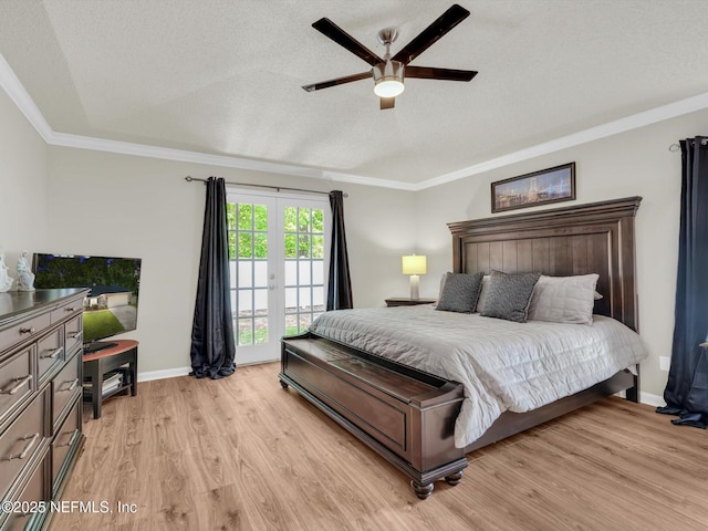 bedroom featuring baseboards, crown molding, a textured ceiling, and light wood finished floors