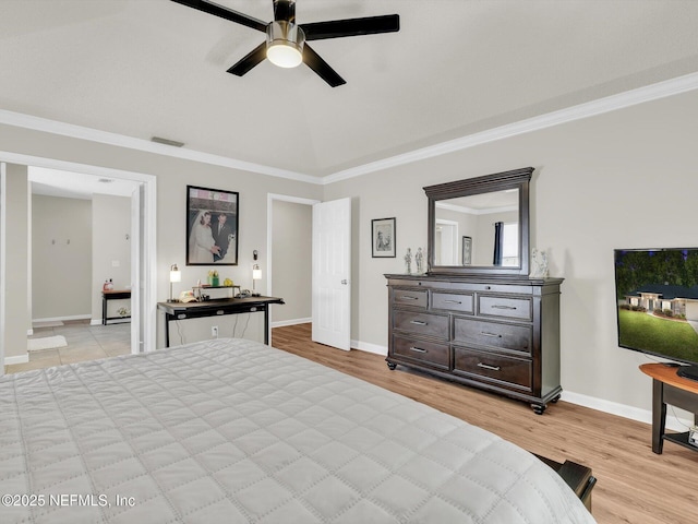 bedroom featuring crown molding, visible vents, light wood-style flooring, vaulted ceiling, and baseboards