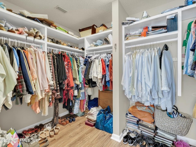 spacious closet featuring visible vents and wood finished floors