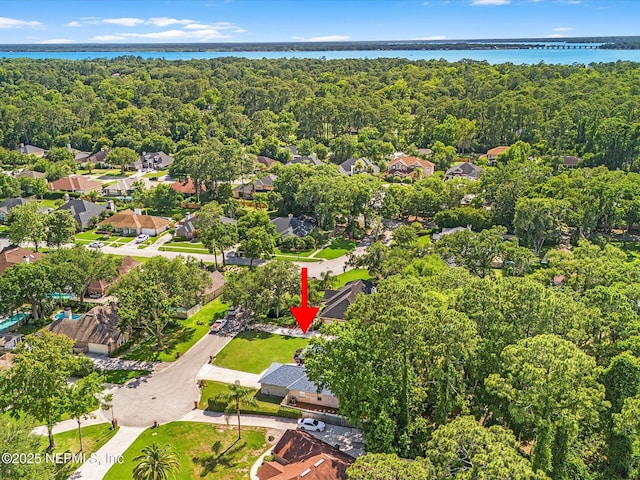 bird's eye view with a water view, a residential view, and a view of trees