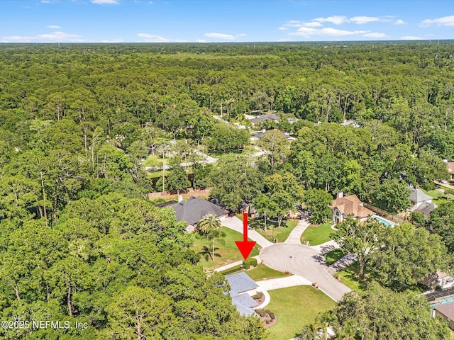 birds eye view of property with a forest view