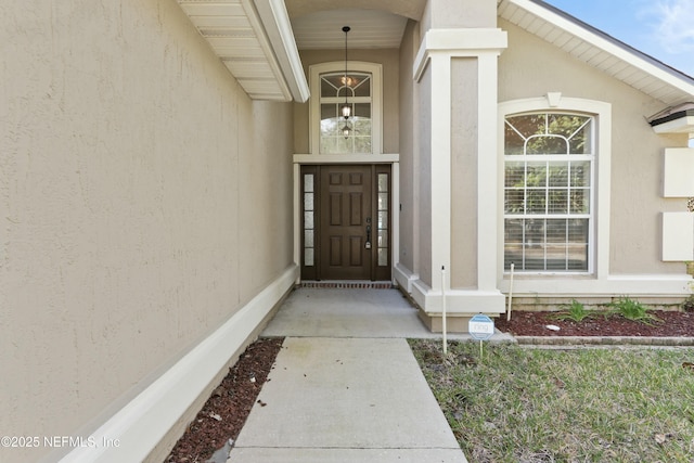 view of exterior entry with stucco siding