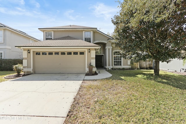 traditional-style house featuring driveway, a garage, a front lawn, and stucco siding