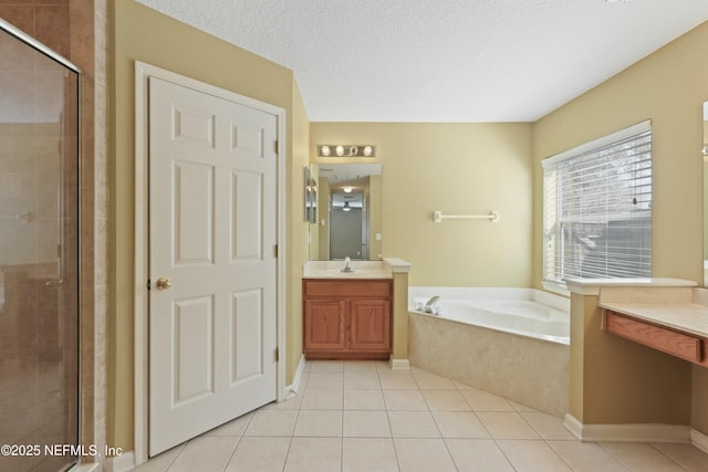 full bathroom featuring a stall shower, tile patterned flooring, a bath, and vanity