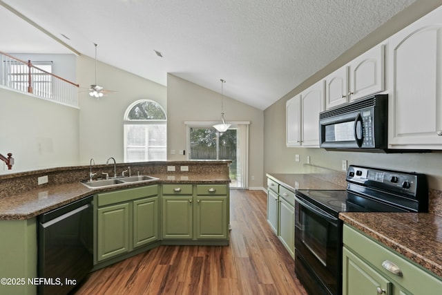 kitchen featuring green cabinets, black appliances, a sink, and white cabinets