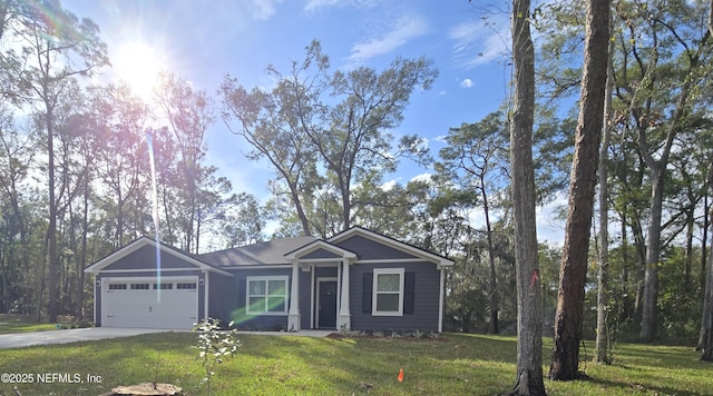 view of front facade with a garage, concrete driveway, and a front yard