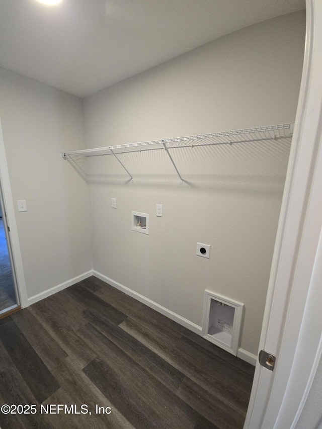 laundry area with hookup for a washing machine, dark wood-type flooring, electric dryer hookup, laundry area, and baseboards