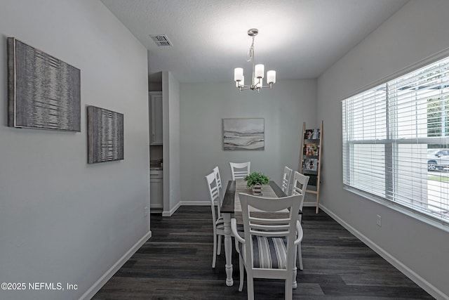 dining space featuring a notable chandelier, baseboards, visible vents, and dark wood-style flooring