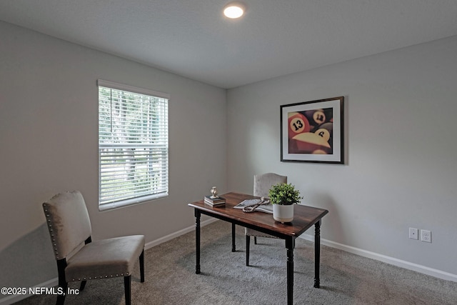 carpeted office space featuring baseboards