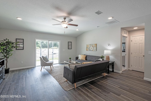 living area featuring dark wood-type flooring, visible vents, and baseboards