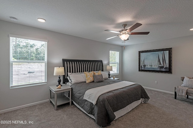 carpeted bedroom with ceiling fan, a textured ceiling, and baseboards