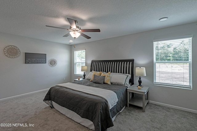 bedroom featuring a ceiling fan, carpet, a textured ceiling, and baseboards