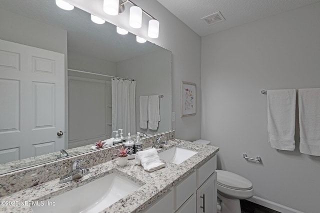 bathroom with baseboards, visible vents, a sink, and toilet