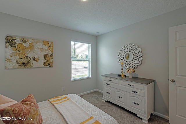 bedroom with light carpet, a textured ceiling, and baseboards