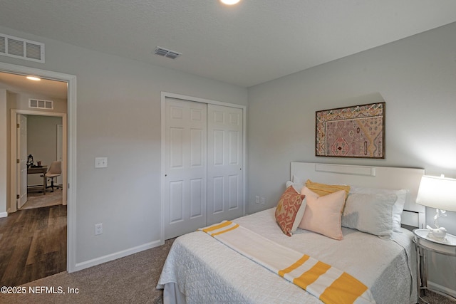 carpeted bedroom featuring a closet, visible vents, and baseboards