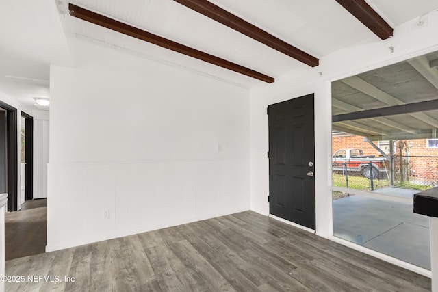 entrance foyer with wainscoting, wood finished floors, and beam ceiling