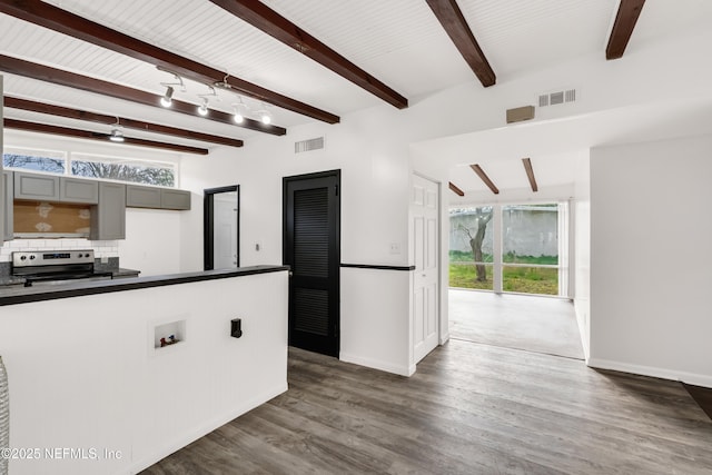 kitchen featuring dark countertops, visible vents, a wealth of natural light, and stainless steel range with electric cooktop