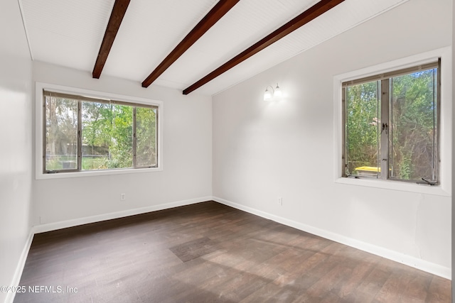 spare room with vaulted ceiling with beams, wood finished floors, and baseboards