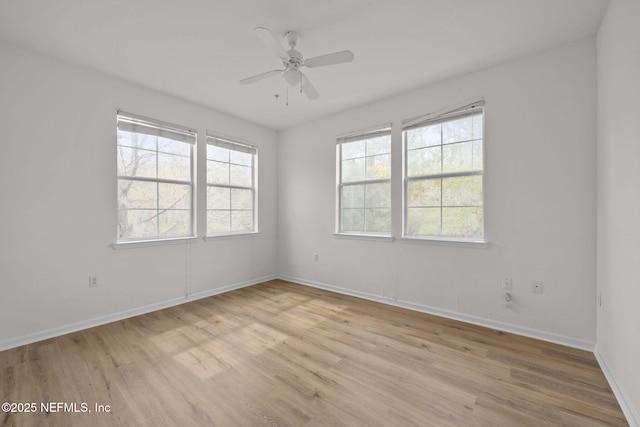 unfurnished room with light wood-style floors, ceiling fan, and baseboards