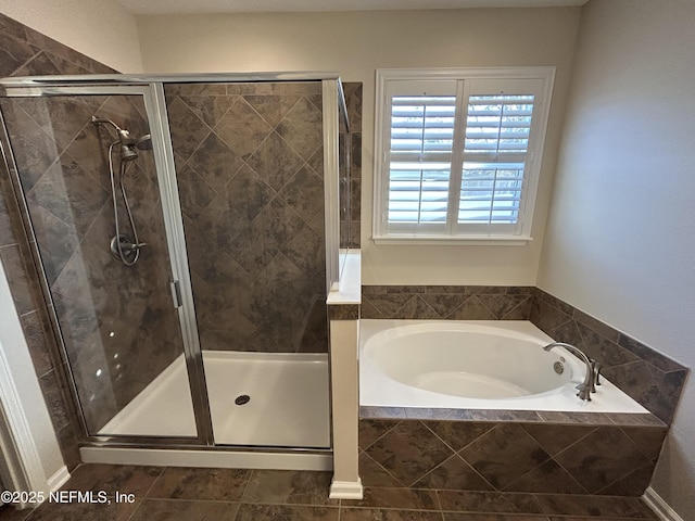 bathroom featuring a bath and a stall shower