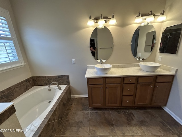 full bathroom featuring a sink, a bath, and double vanity