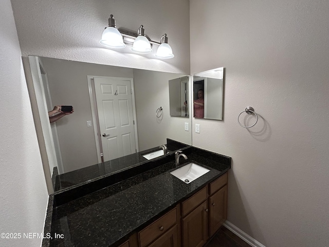 bathroom with baseboards and vanity