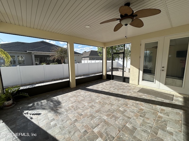 unfurnished sunroom with wood ceiling, french doors, and ceiling fan