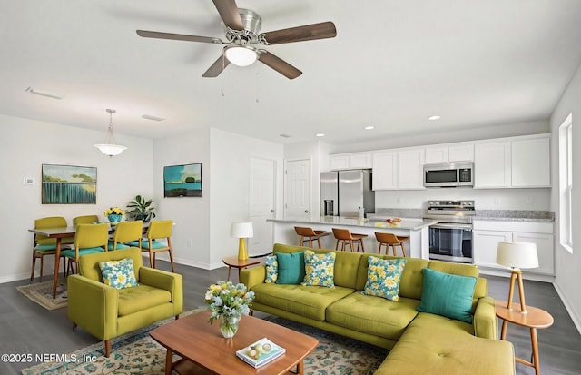 living area with ceiling fan, dark wood-style flooring, recessed lighting, and baseboards