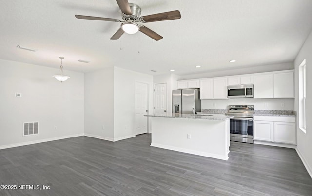 kitchen with appliances with stainless steel finishes, dark wood-style flooring, visible vents, and white cabinets