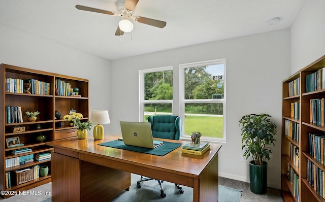 home office featuring baseboards and a ceiling fan