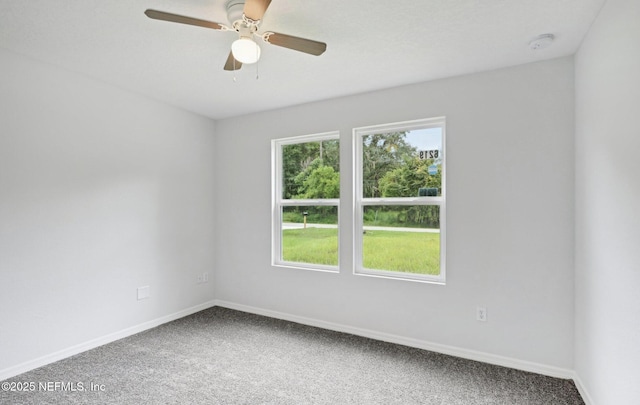 empty room featuring carpet flooring, ceiling fan, and baseboards