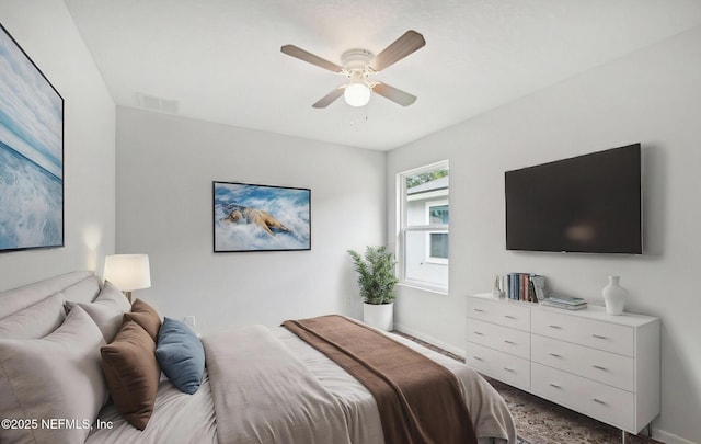 bedroom with ceiling fan, visible vents, and baseboards