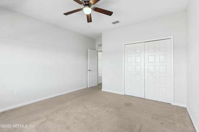 unfurnished bedroom with a closet, baseboards, visible vents, and carpet flooring