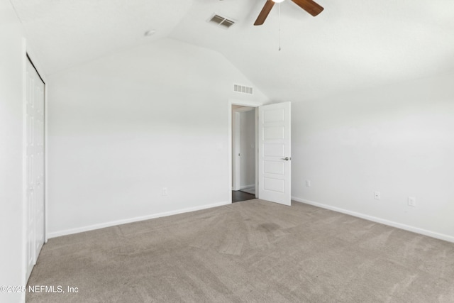 unfurnished bedroom featuring lofted ceiling, carpet floors, visible vents, and baseboards