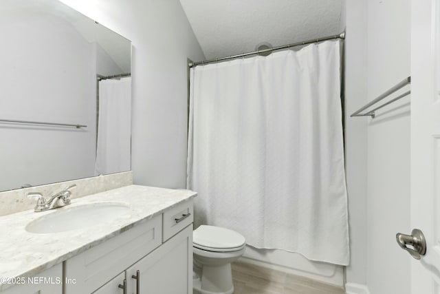 full bath with a textured ceiling, wood finished floors, vanity, and toilet