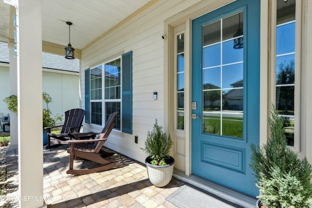 view of exterior entry with covered porch