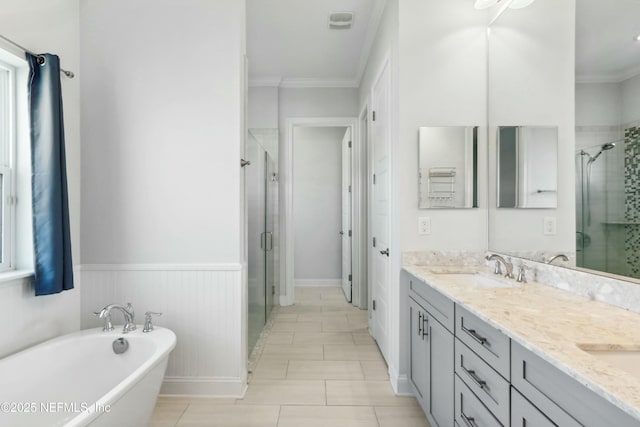 bathroom featuring double vanity, a soaking tub, ornamental molding, a sink, and a shower stall