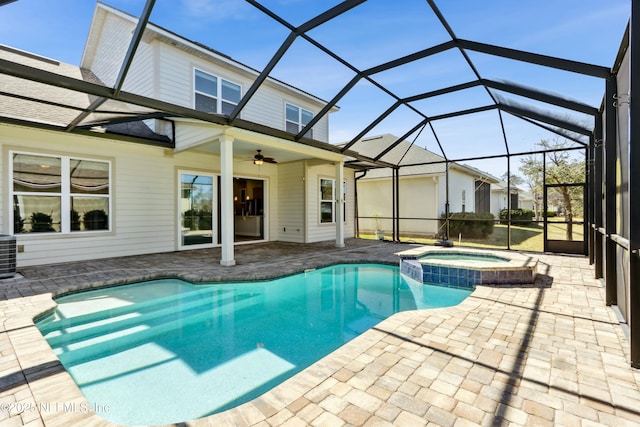 view of swimming pool with ceiling fan, a patio, a lanai, and a pool with connected hot tub