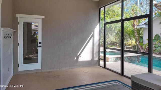 interior space with a textured wall and concrete floors