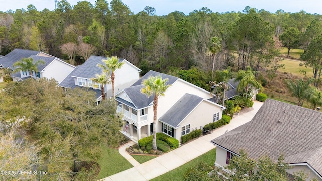 birds eye view of property featuring a wooded view