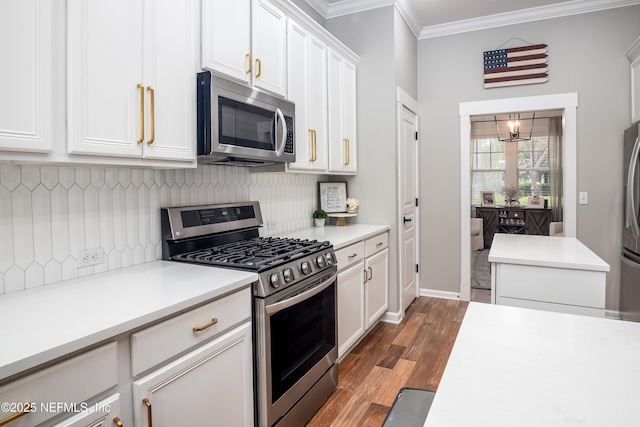 kitchen with crown molding, light countertops, appliances with stainless steel finishes, white cabinetry, and wood finished floors