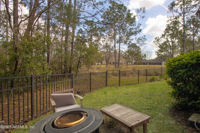 view of yard featuring an outdoor fire pit and a fenced backyard