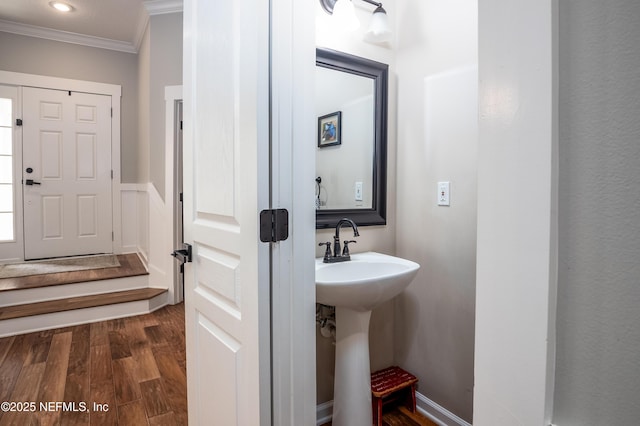 bathroom featuring crown molding and wood finished floors