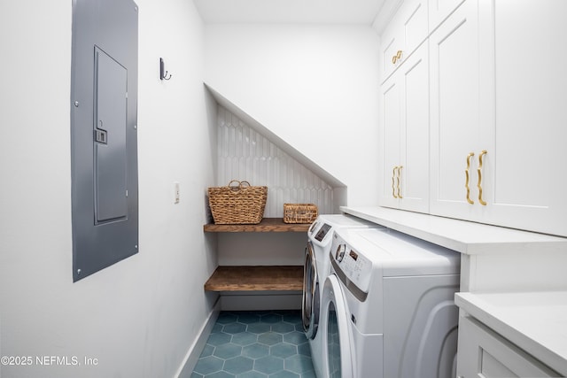 laundry area with cabinet space, electric panel, baseboards, dark tile patterned floors, and separate washer and dryer