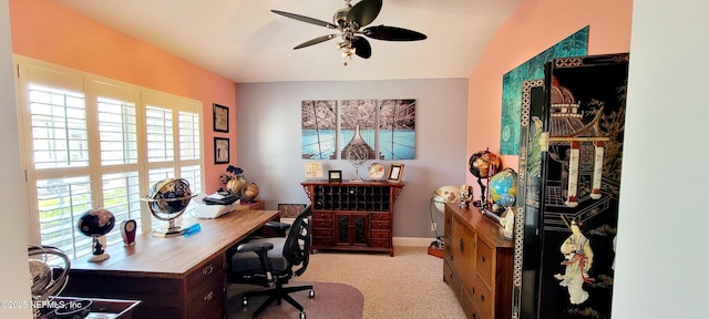 home office featuring ceiling fan, baseboards, and light colored carpet