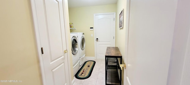 clothes washing area featuring laundry area, light tile patterned floors, baseboards, and independent washer and dryer