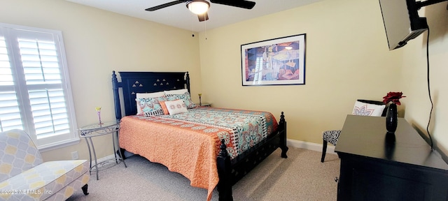 carpeted bedroom with a ceiling fan and baseboards