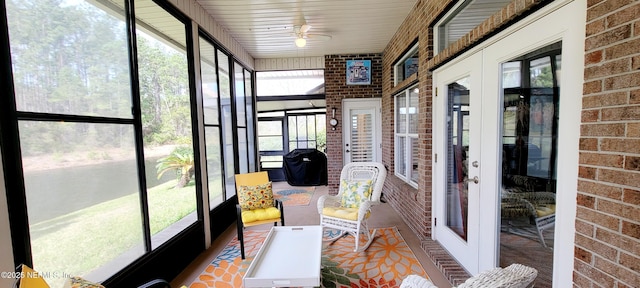 sunroom with ceiling fan, french doors, and a healthy amount of sunlight