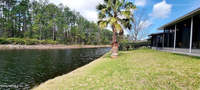 view of yard featuring a water view and a sunroom